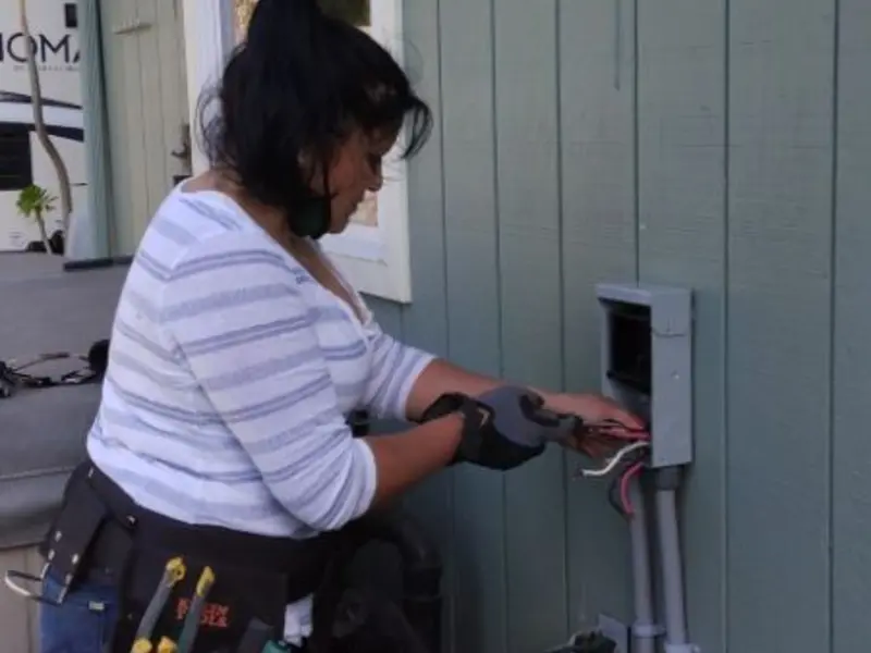 Licensed electrician wiring an exterior subpanel in Plain City